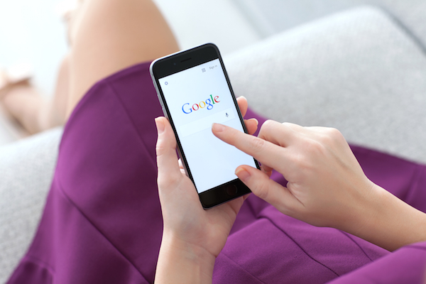 Foto che mostra una donna che usa Google da mobile